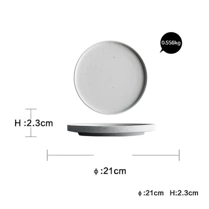 Modern speckled white ceramic dinner plate set with minimalist textured surface and slightly raised rim for dining use