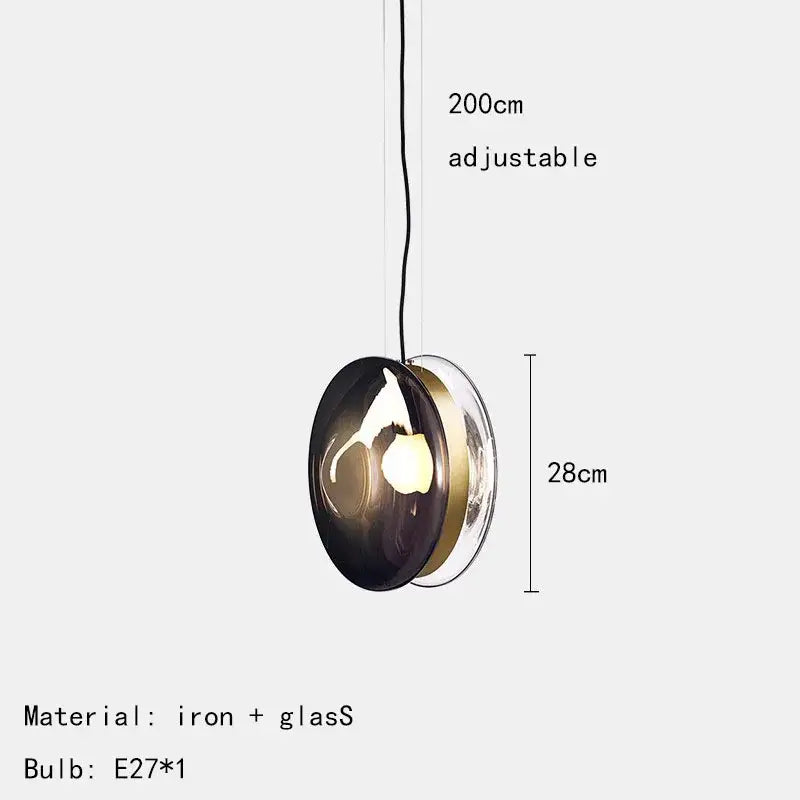 Modern spherical glass pendant lights with dark smoked and clear glass panels accented by brass metallic trim for dining rooms