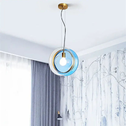 Modern blue and white glass pendant lights with brass-finished metal frame for elegant living space or dining room lighting
