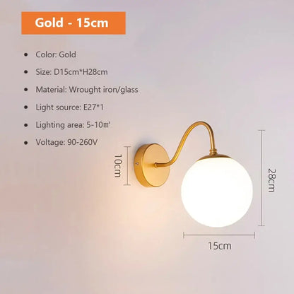 Modern spherical glass shade gold wall lamp with curved wrought iron arm and round glass globe for bedroom use