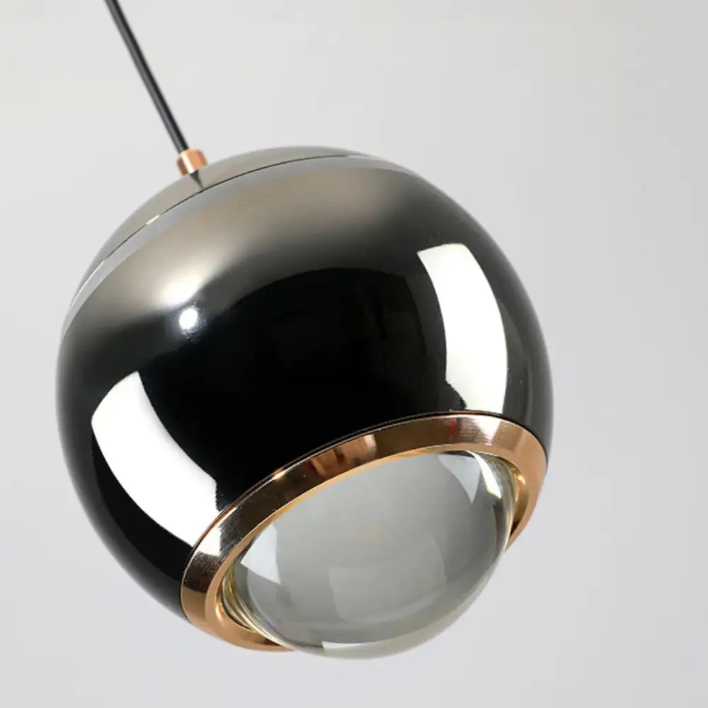 A sleek spherical pendant light with glossy black silver finish and gold ring for decorbites led bedside lifting use
