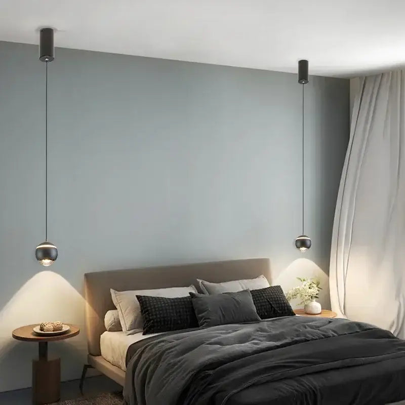 Modern spherical black led bedside pendant light with sleek cylindrical fixtures and thin cords for bedroom decorbites decor