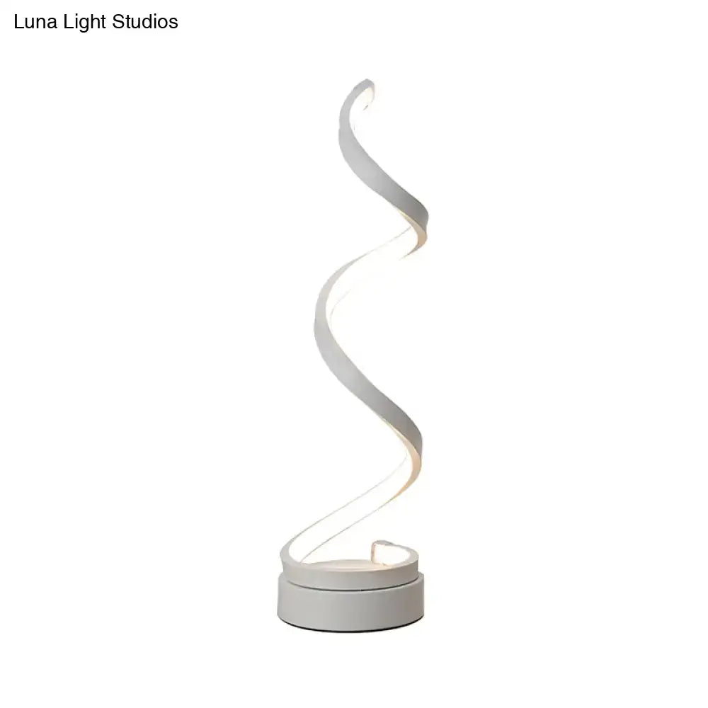 A modern spiral black white gold led table lamp with a minimalist curved design for bedroom task light