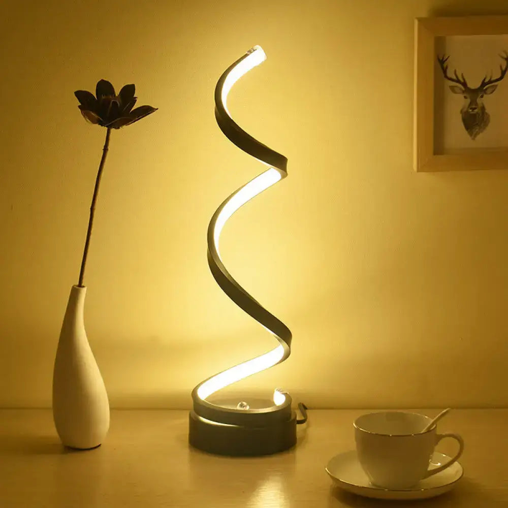 Modern spiral black white gold led table lamp with glowing white led light strip and dark metallic finish for bedroom task light