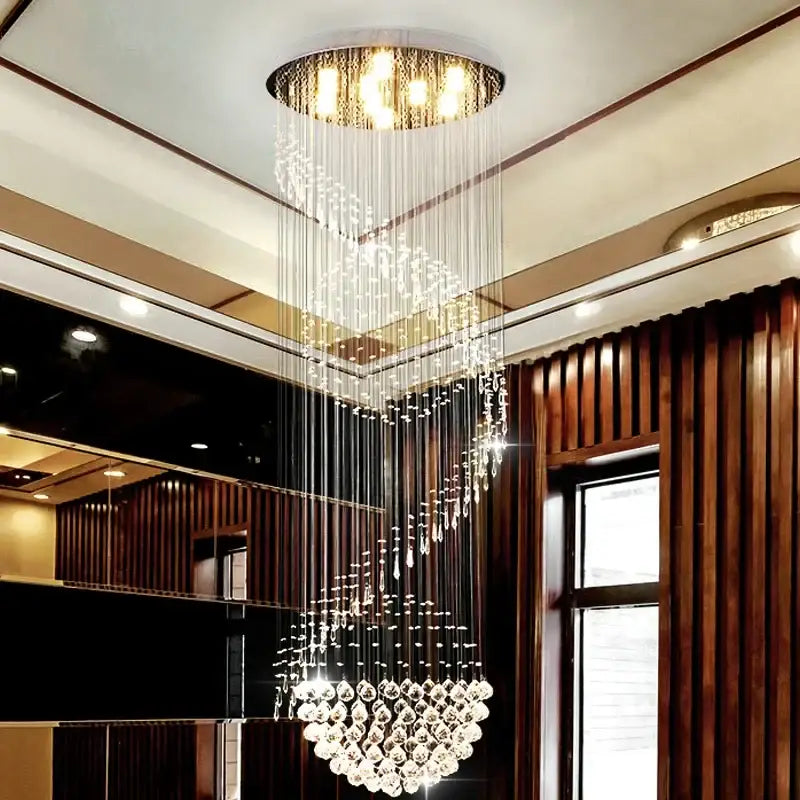 Modern spiral crystal staircase chandelier with gold-toned top and clear faceted crystals by decorbites crystal staircase