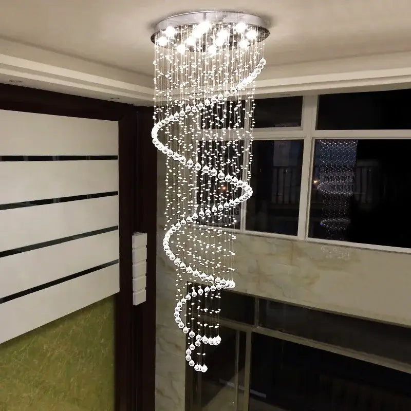 A modern decorbites crystal chandelier with a sparkling spiral design and chrome finish for living room staircase