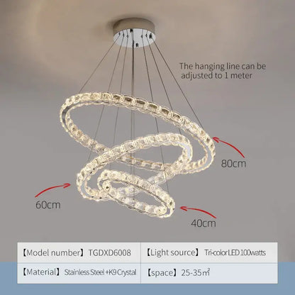 A modern three-tiered spiral decorbites crystal chandelier with clear crystal beads and stainless steel framing for living room
