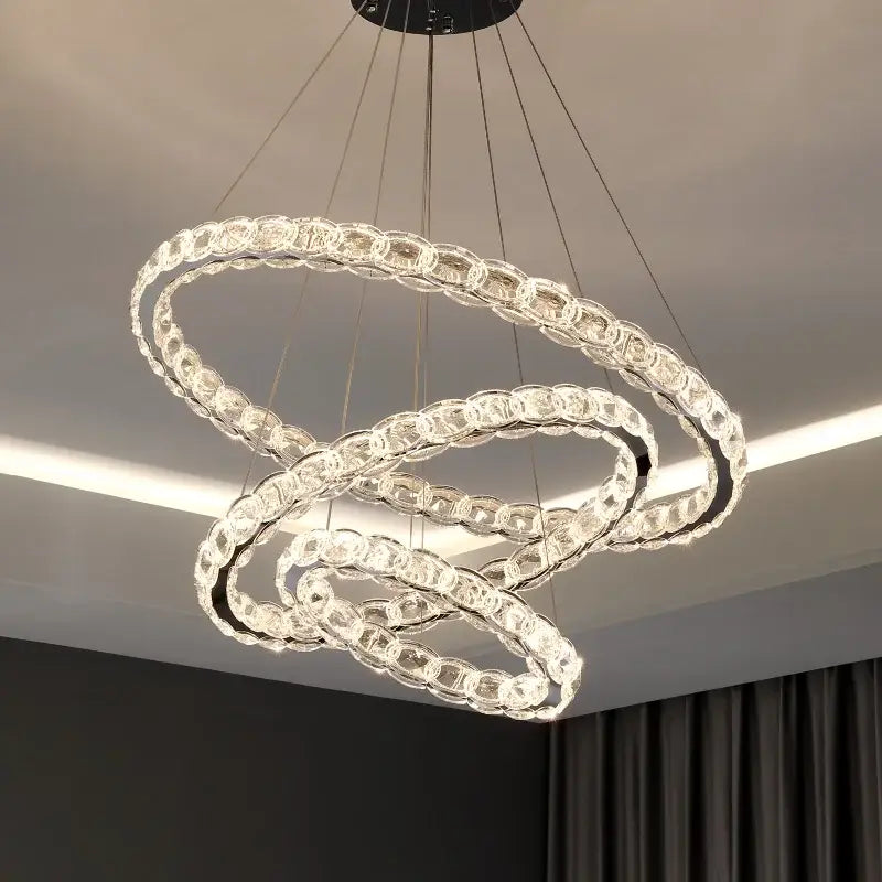 Modern spiral interlocking decorbites crystal chandelier with clear faceted beads and sleek metallic finish for living room
