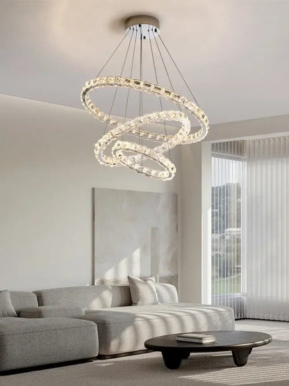 Modern spiral interlocking decorbites crystal chandelier with three clear faceted crystal rings suspended by metallic wires