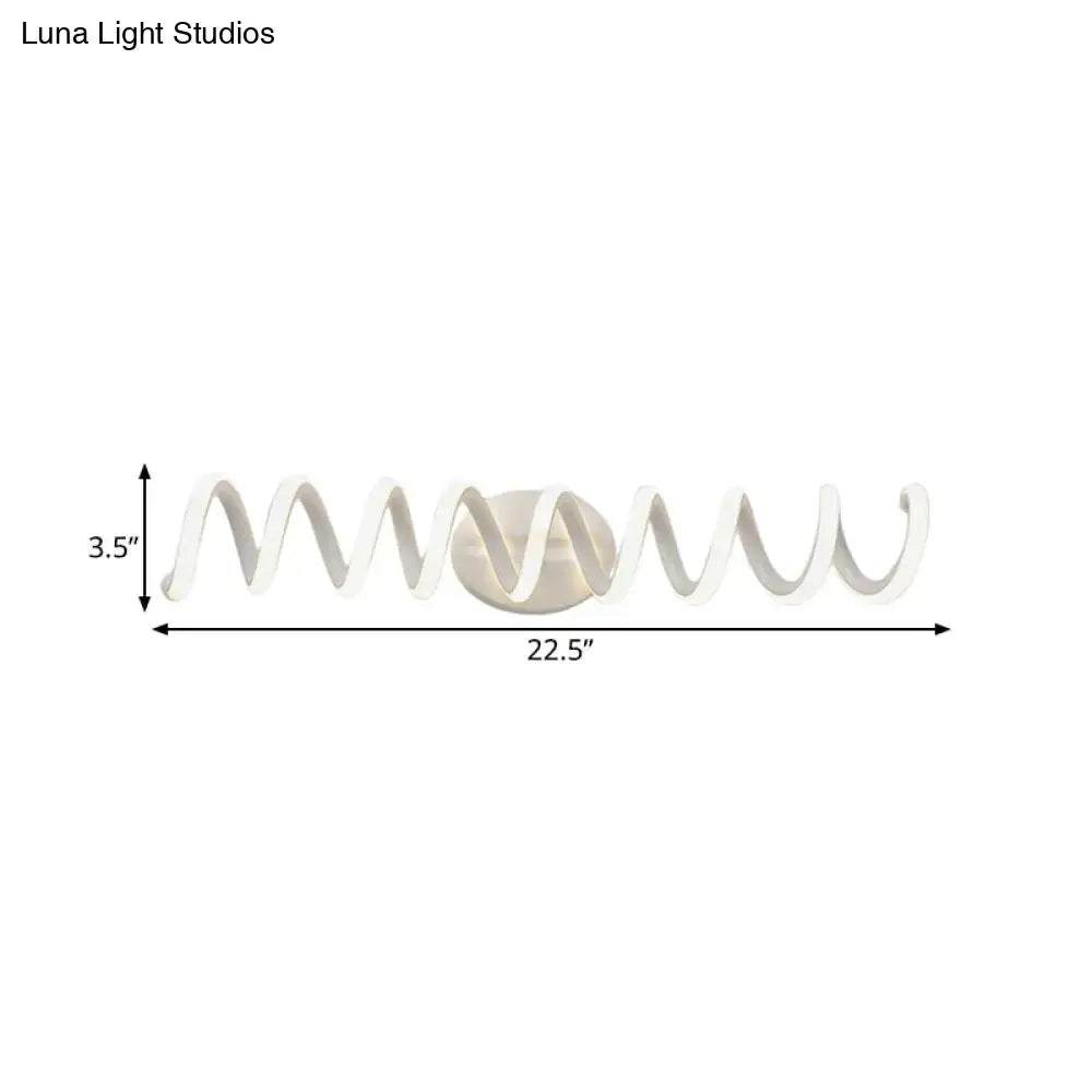 Modern white spiral wall light with sleek curved design and metallic center offering natural warm led illumination