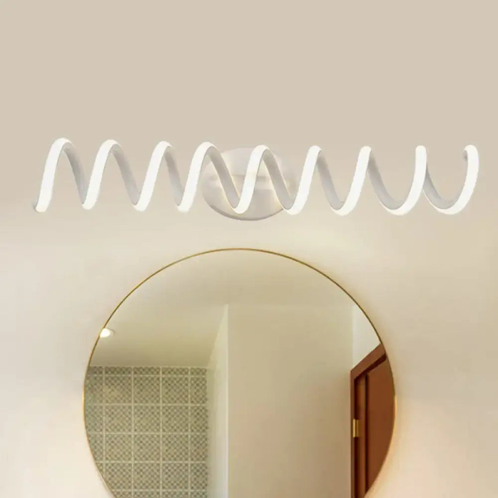 White modern spiral wall light with sleek wavy design mounted above a round mirror featuring natural warm LED illumination