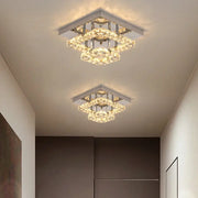 Two modern square chrome ceiling chandeliers with layered clear crystals emitting warm light decorbites crystal led