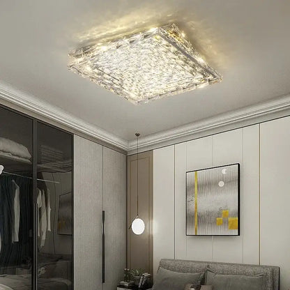 Modern square crystal led ceiling light in silver and chrome with textured faceted surface and warm glowing illumination