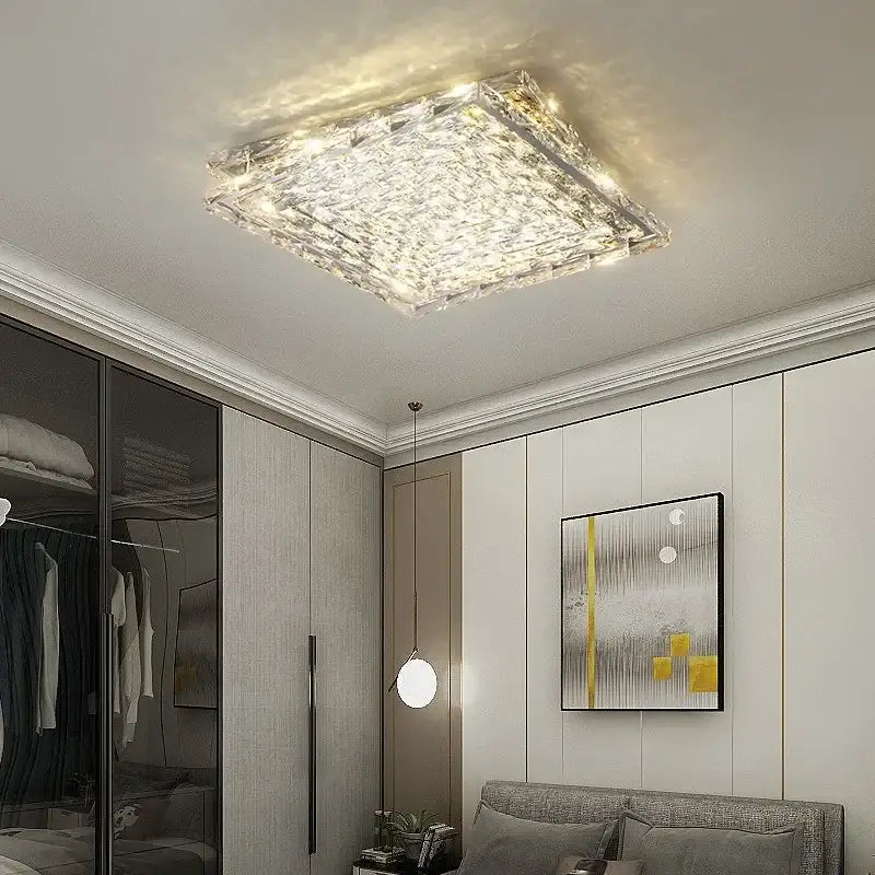 Modern square crystal led ceiling light in silver and chrome with textured faceted surface and warm glowing illumination