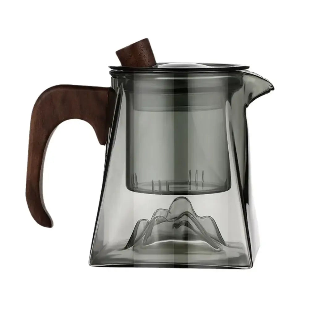 A sleek dark gray glass tea pot with wooden handle and mountain-shaped mesh infuser for modern kitchen use