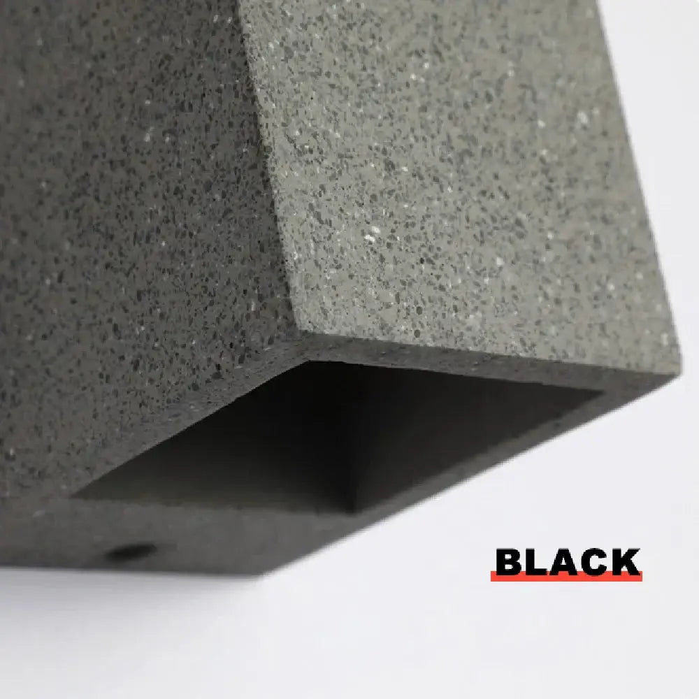Black textured concrete outdoor wall lamp with matte finish and speckled surface decorbites cement wall sconce