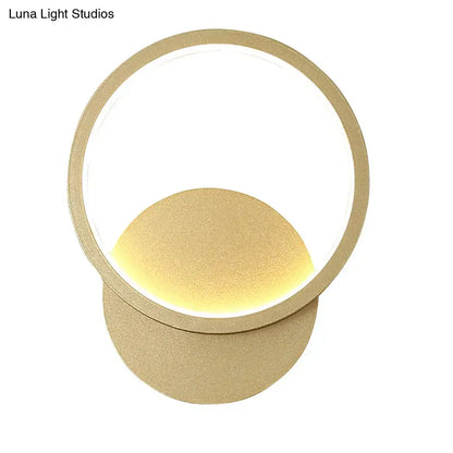 Modern gold-toned circular wall sconce lighting with minimalist concentric rings for living room wall sconce use