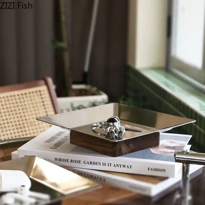 Modern square metallic fruit bowl tray with silver astronaut-themed ring display and dark wood base for living room use