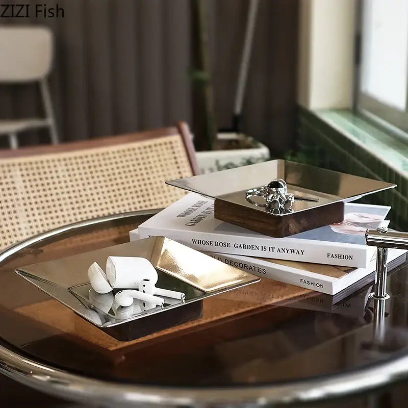 Modern square metallic and dark wood fruit bowl tray with polished silver finish and dark wood base for living room use