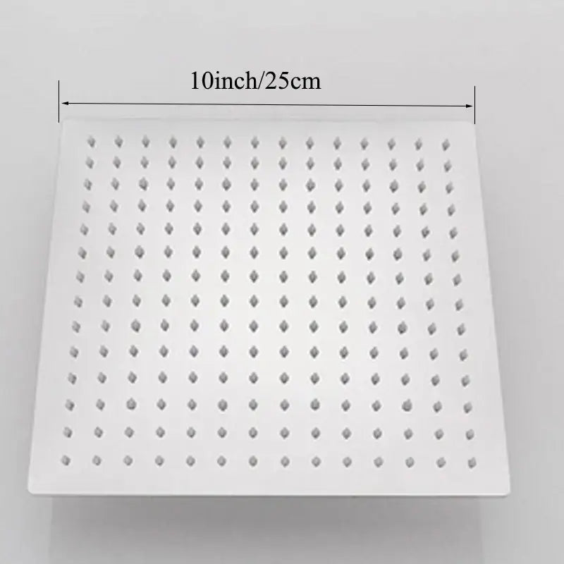 Modern square rain shower head in chrome with white diamond-shaped nozzles for an even rainfall spray