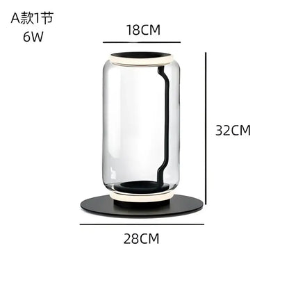 Clear glass cylindrical vase with black rim and base featured on modern stacked glass led floor lamp for living room lighting