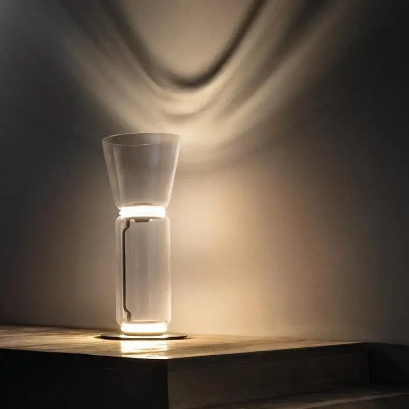Modern stacked glass led floor lamp with a minimalist translucent glass base and warm ambient light for living room lighting