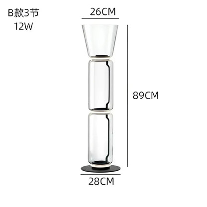 Modern stacked glass led floor lamp with tall transparent three-section design and black circular base for living room lighting