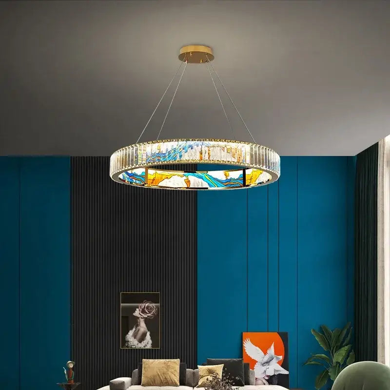 A modern pendant chandelier with gold ceiling mount clear crystal rods and stained-glass panels in blues and yellows