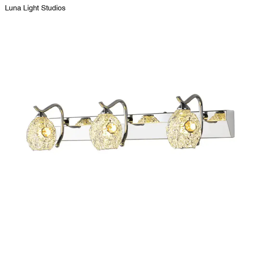 Modern stainless steel wall light with three textured golden glass shades providing warm white light for bathroom use
