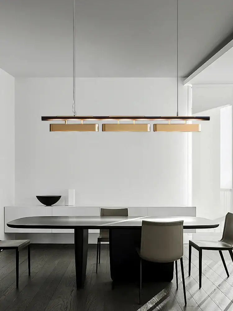 Modern stainless steel pendant lamp with three brushed gold rectangular panels hanging by thin cables for dining room decorbites