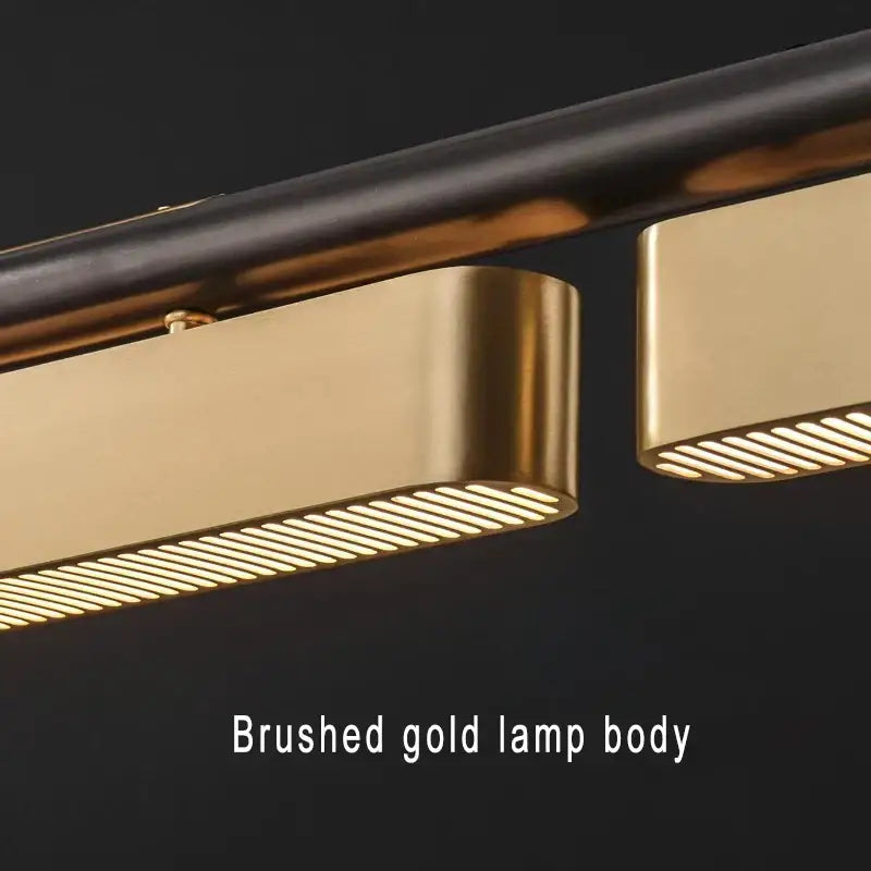 Modern stainless steel pendant lamp with brushed gold finish and slatted light diffusers for dining room decorbites