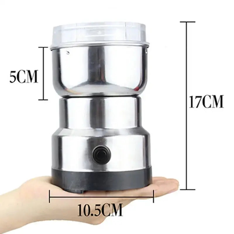 Compact modern stainless steel electric grinder with clear plastic lid and black base for grinding grains in kitchen