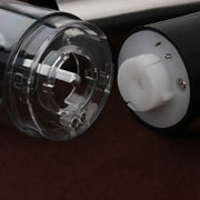 Clear plastic and white components of a modern stainless steel electric salt pepper grinder housing for kitchen use