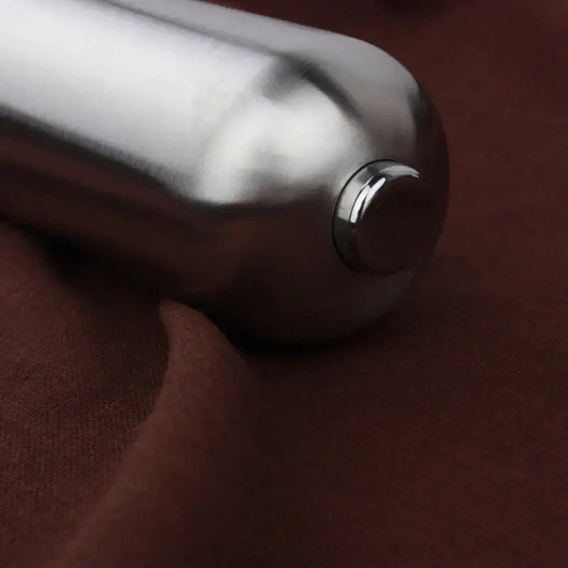 Modern stainless steel electric salt pepper grinder with shiny metallic cylindrical body and smooth reflective surface