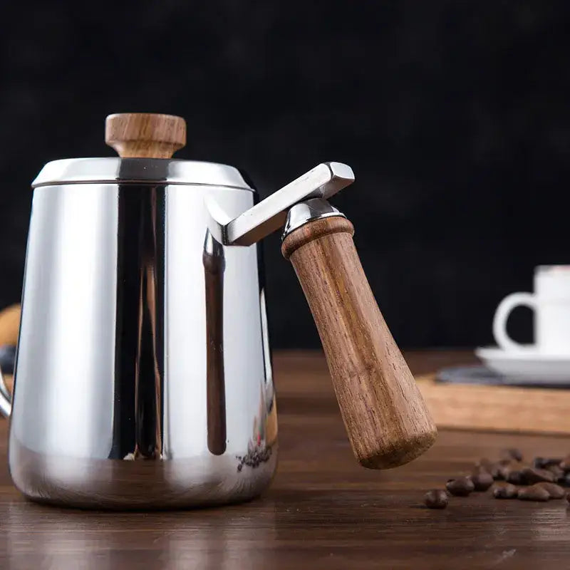 Modern stainless steel gooseneck drip coffee pot with wooden handle and lid featuring a sleek reflective surface
