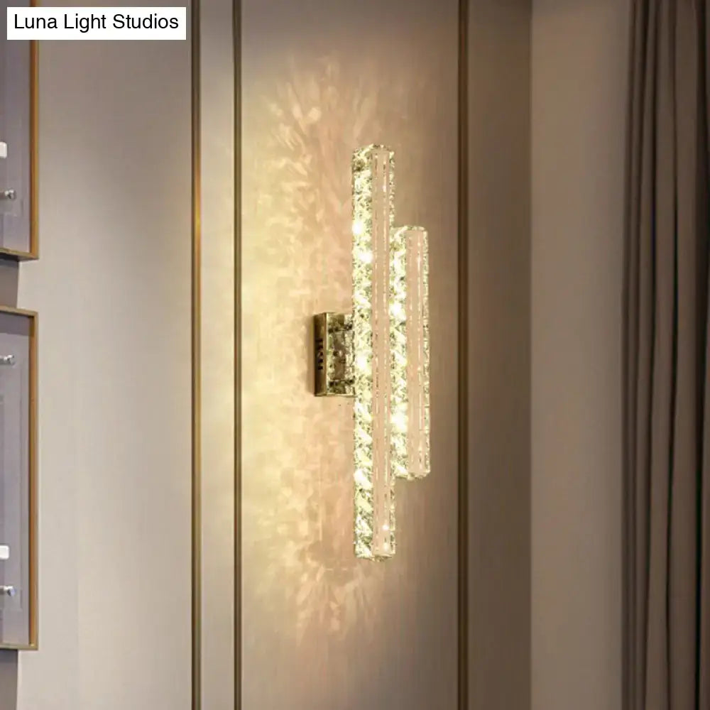 Modern stainless steel k9 crystal led wall mount light with two faceted glass bars emitting warm glow for living room