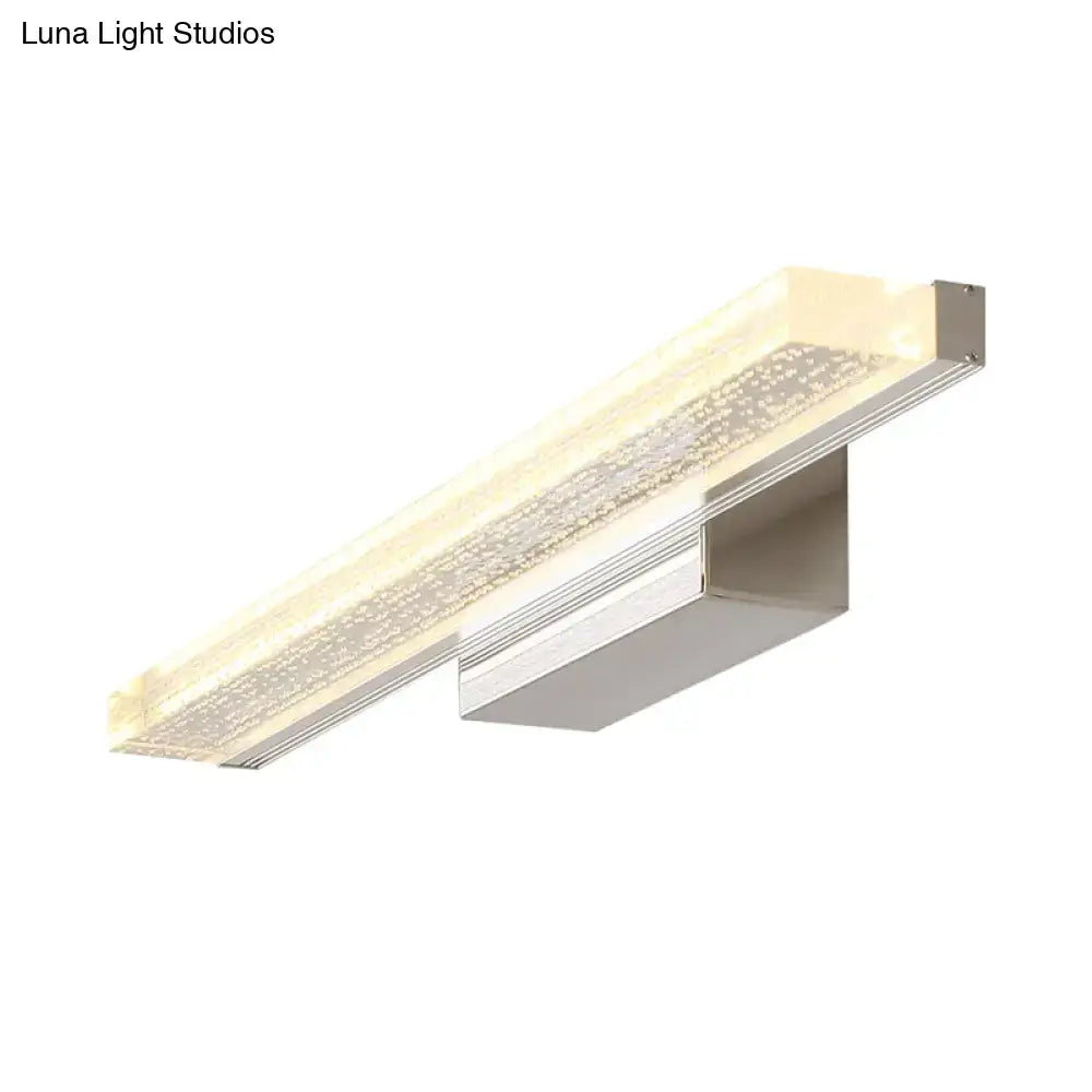 Modern stainless steel led bathroom light with frosted glass panel and sparkling beads emitting warm ambient light