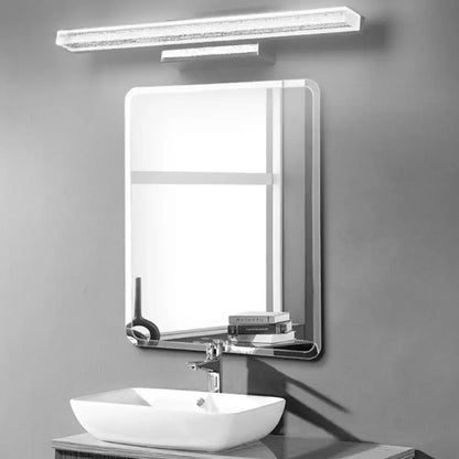 Modern rectangular bathroom mirror with sleek chrome frame and integrated shelf above white vessel sink with stainless steel led light