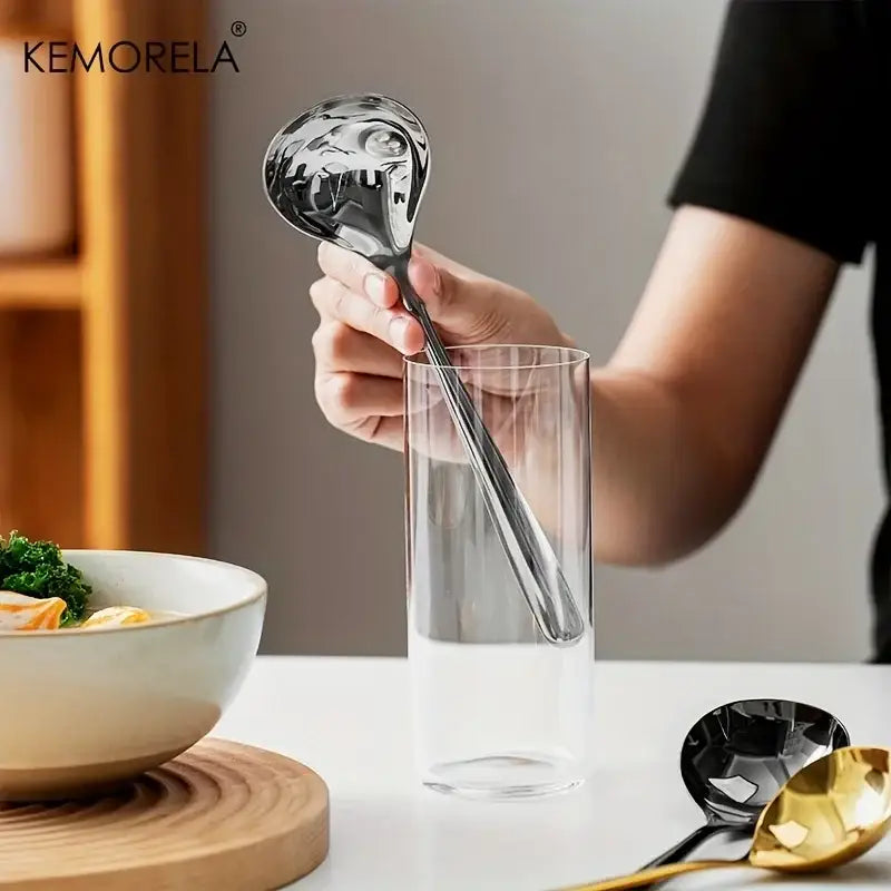 Modern stainless steel small gravy ladle with sleek design and reflective surface for dining room sauce serving