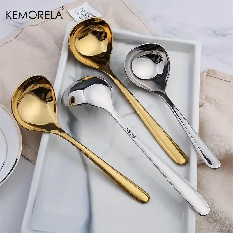 Set of four modern stainless steel small gravy ladles in polished gold and silver finishes with long handles for dining