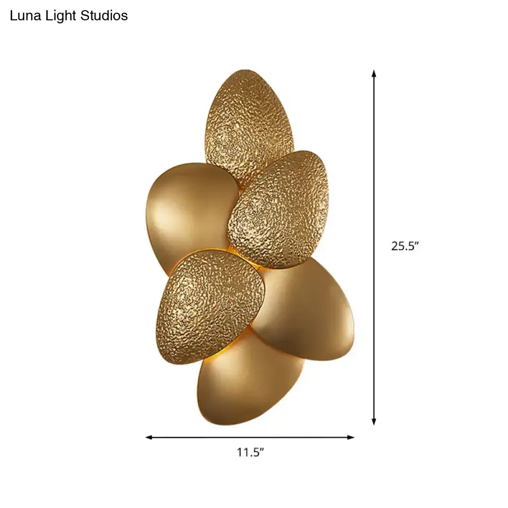 Gold-colored modern stainless steel squama wall light with textured leaf-shaped design for bedroom sconce lighting