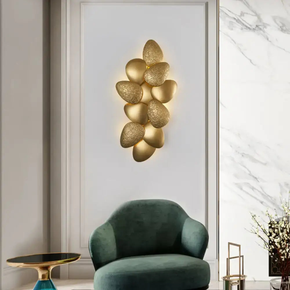 Modern gold textured stainless steel squama wall light featuring a cluster design for bedroom use