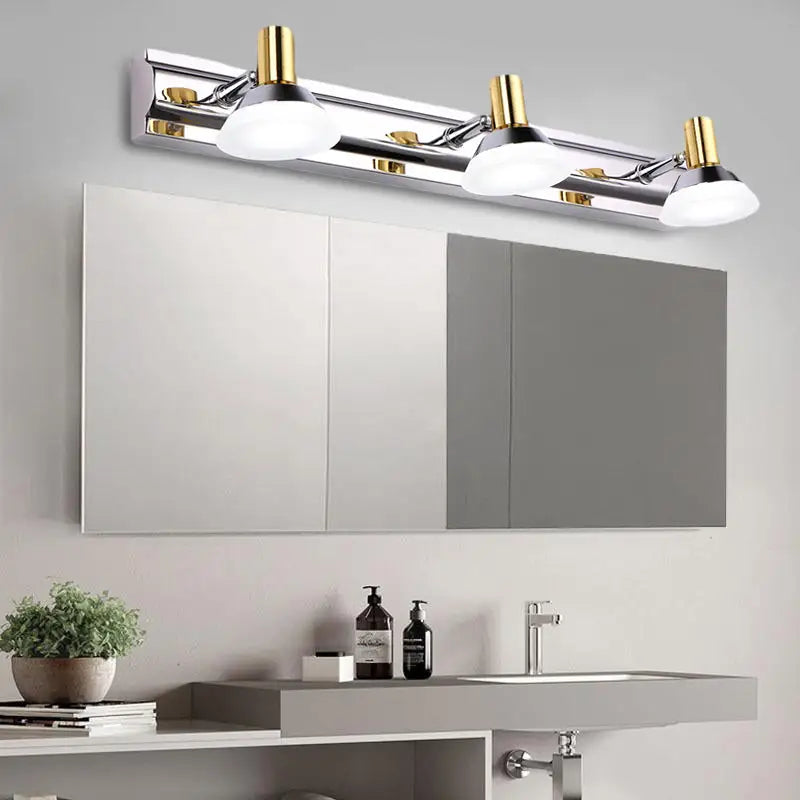 Modern stainless steel wall light with chrome and gold finish and acrylic cone shades for bathroom vanity use