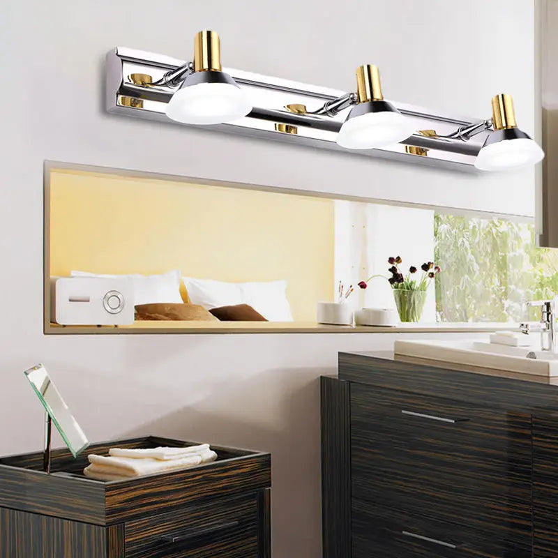 Modern stainless steel wall light with chrome and gold finish and acrylic cone shade for bathroom vanity use