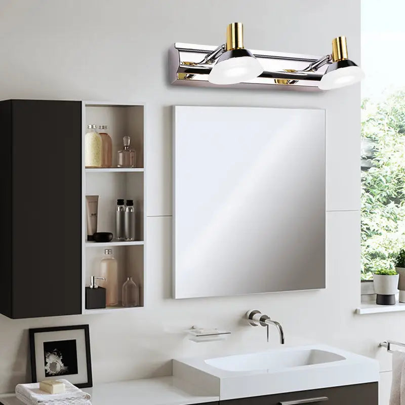 Modern stainless steel wall light with chrome and gold finish featuring two acrylic cone shades for bathroom vanity