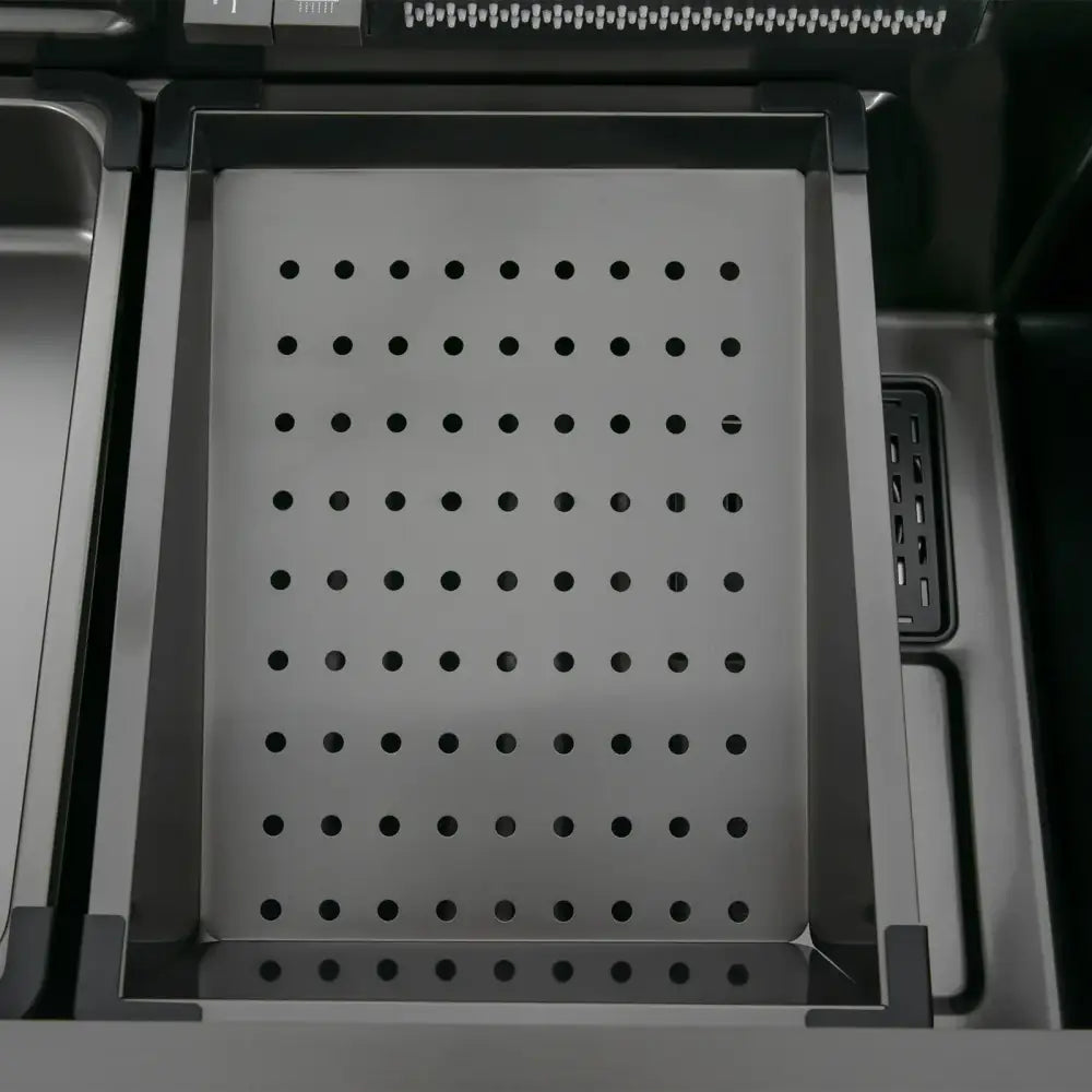 Modern stainless steel waterfall kitchen sink accessory with a rectangular tray featuring evenly spaced circular holes