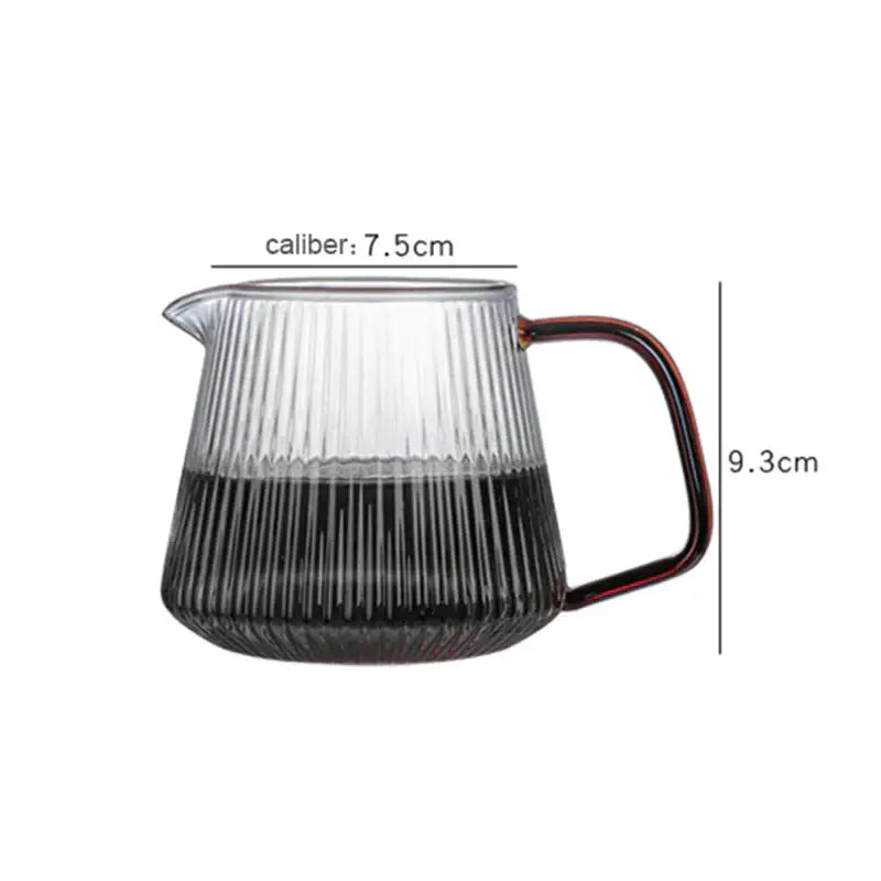 Modern striped glass coffee pot with vertical ridges and amber handle containing black liquid for kitchen use