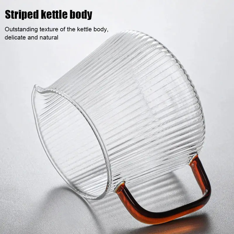 Modern striped glass coffee pot with vertical ribbed texture and curved amber handle for stylish kitchen use