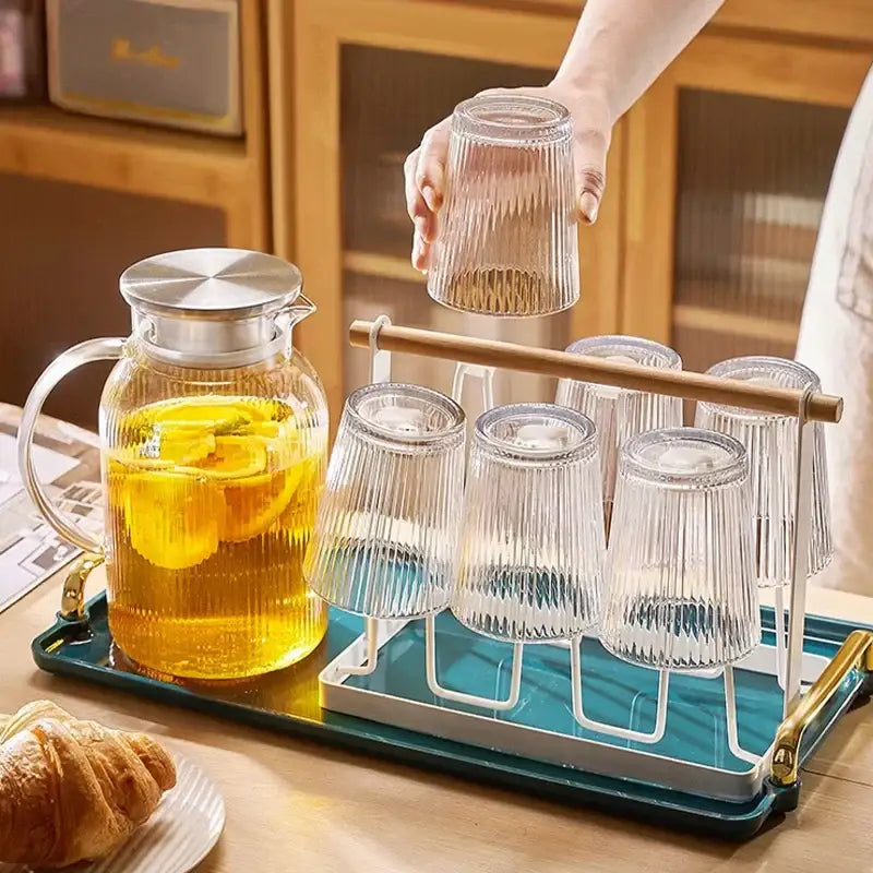Clear glass cold water kettle set with vertical ribbed texture and silver-toned lid for modern kitchen use