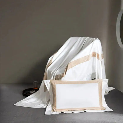 White satin pillowcase with beige textured border part of modern striped white and beige king size luxury bedding set decorbites